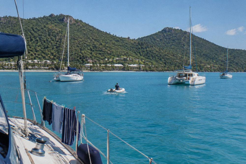 Anchored sailing yachts in a turquoise Whitsunday island bay